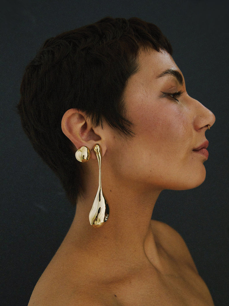 FARIS BOLO Drops in gold-plated bronze worn on model. Styled with SUMO Stud in gold-plated bronze