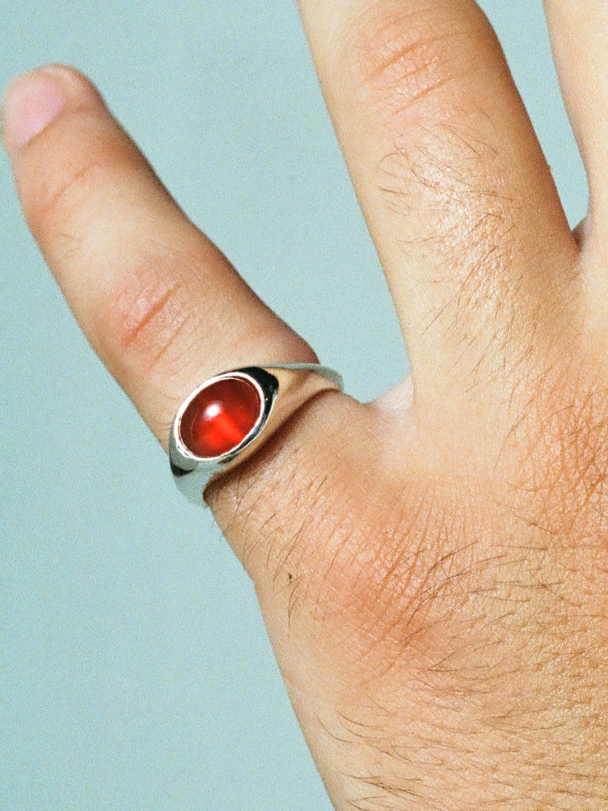 Close up image of FARIS EYE Ring in sterling silver with carnelian pictured on male model