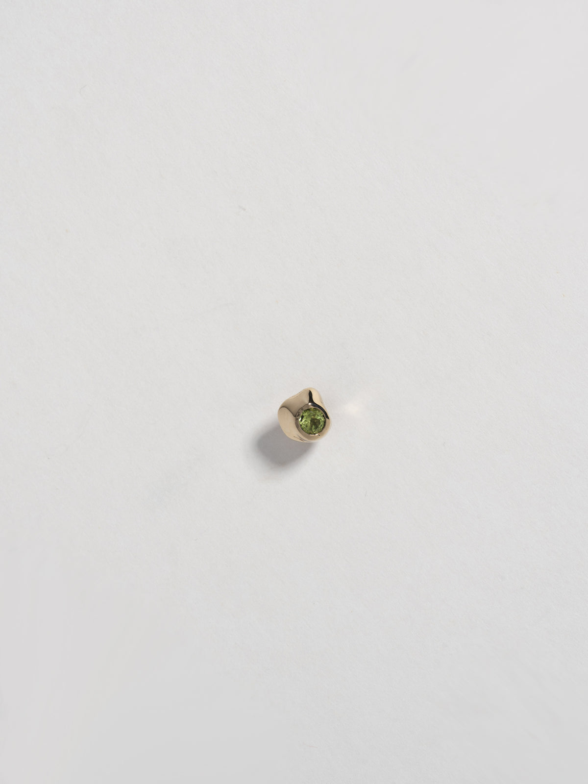 Close up product image of KIRA Stud in 14k gold with peridot, shown on white background (front view)