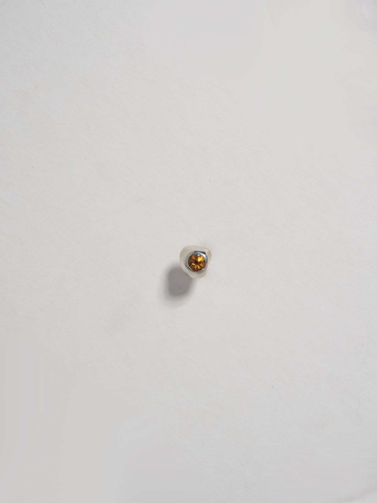 Close up product image of FARIS KIRA Stud in sterling silver with citrine, shown on white background (front view)