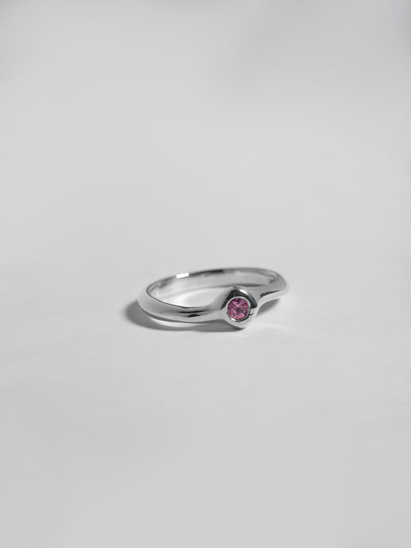 Close up product image of FARIS SUGAR Ring in sterling silver with pink sapphire. (front view, laid flat on white background)