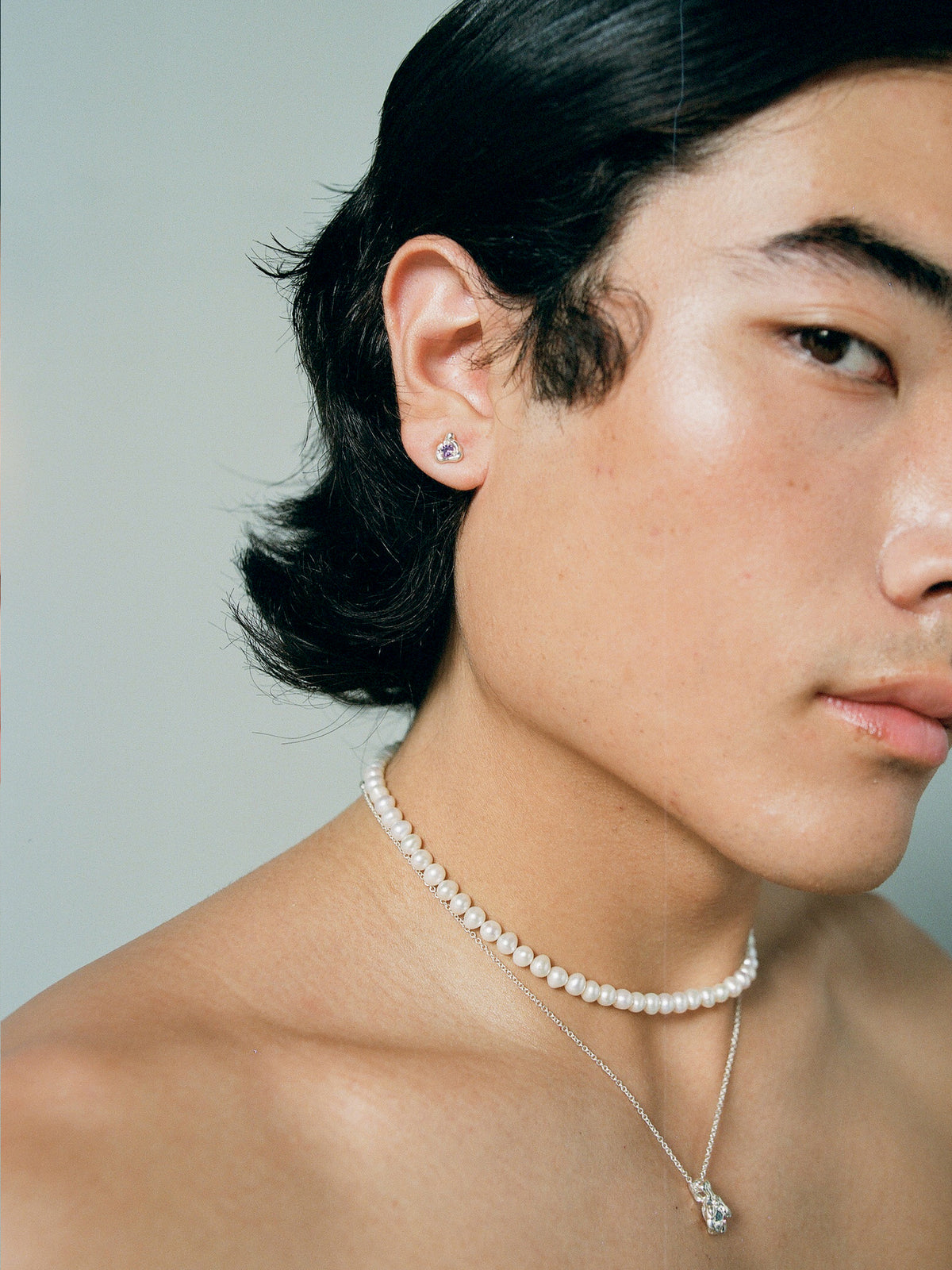 FARIS TASH Stud in sterling silver with purple amethyst. Styled on male model with PATTA Collar layered over GOBBO Necklace in sterling silver with blue sapphire
