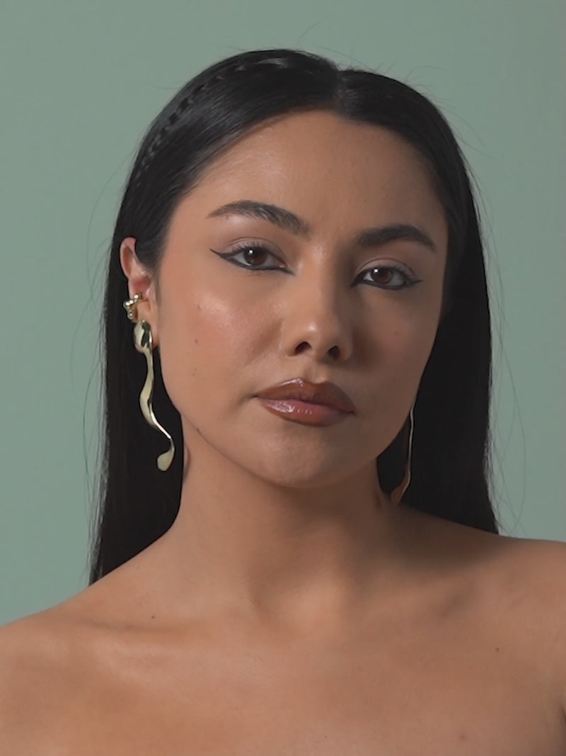 Short clip of FARIS VIVA Earrings in gold-plated bronze, shown on model. Styled with SEEP Ear Cuff in gold-plated bronze