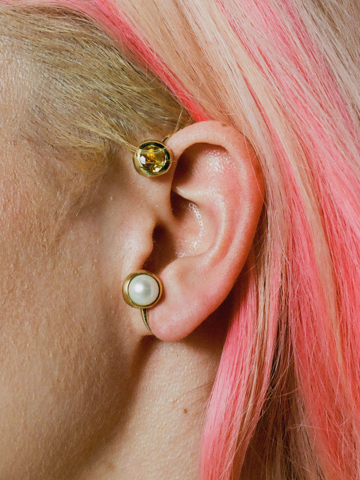 Model wearing the gold plated BI ear cuff adorned with citrine and a freshwater pearl