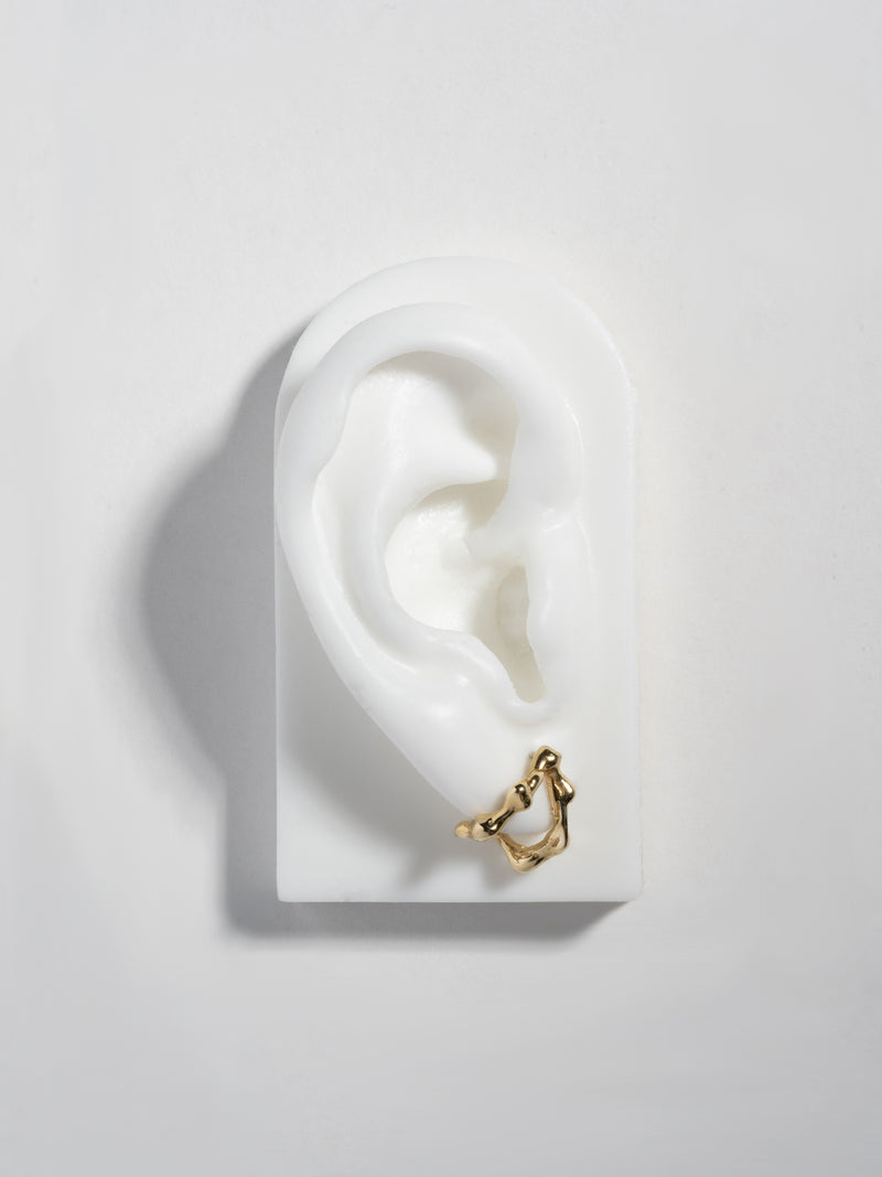 LAVA Dua earring in 14k gold plate, shown on faux ear display