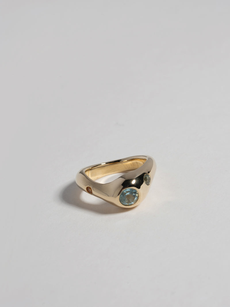 Close up product image of FARIS BAE Ring in gold-plated bronze (front view). Face embedded with 5mm round topaz, with 3mm green sapphire and 2.3mm orange sapphire off to the sides