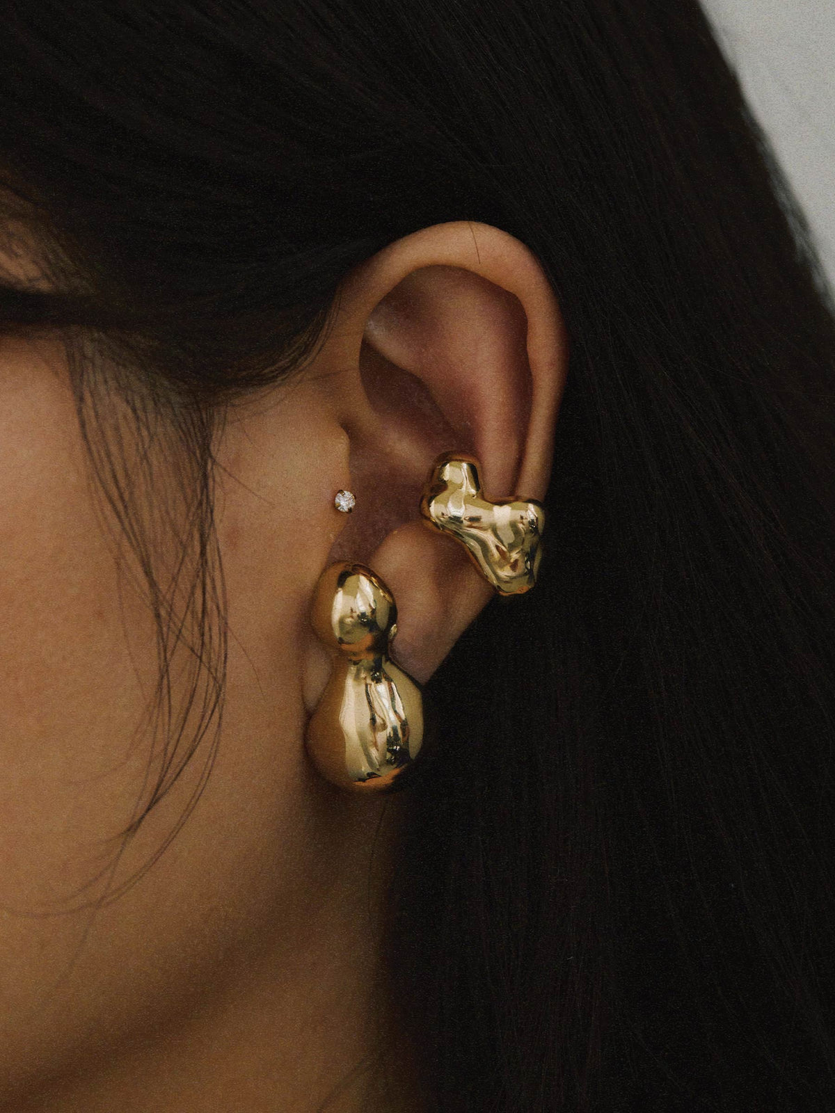 FARIS KUMO Ear Cuff in gold-plated bronze worn on model, styled with BOLO Stud in gold-plated bronze