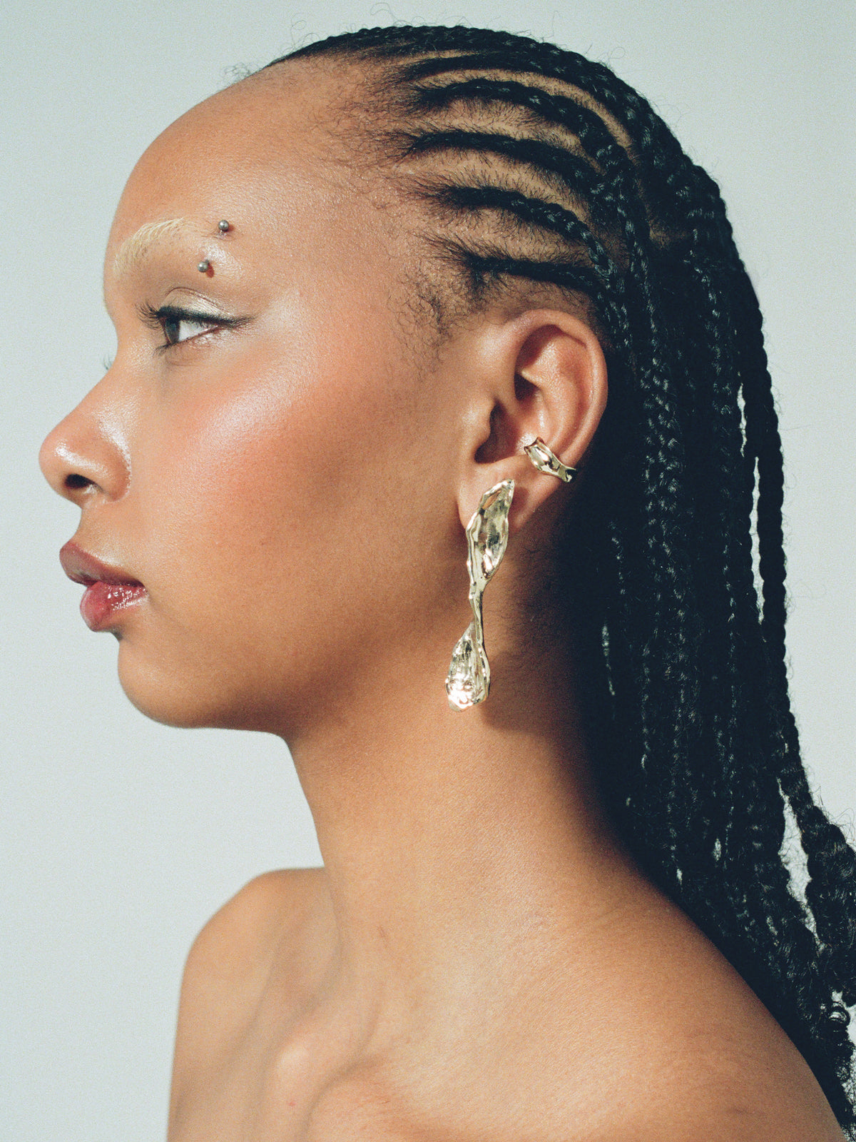 COAST Ear Cuff in gold plated bronze on model