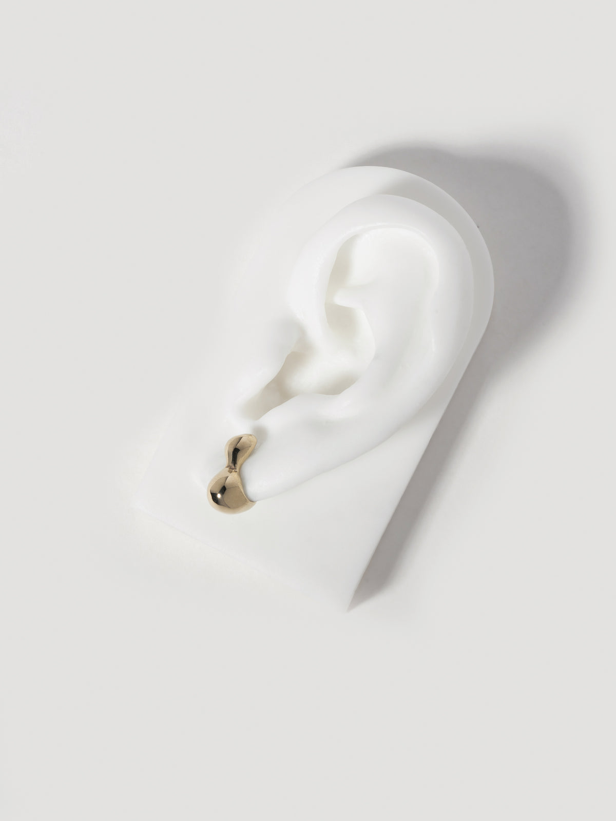 Product image of FARIS CHAMELLE Stud in 14k Gold, shown on white silicon ear display.