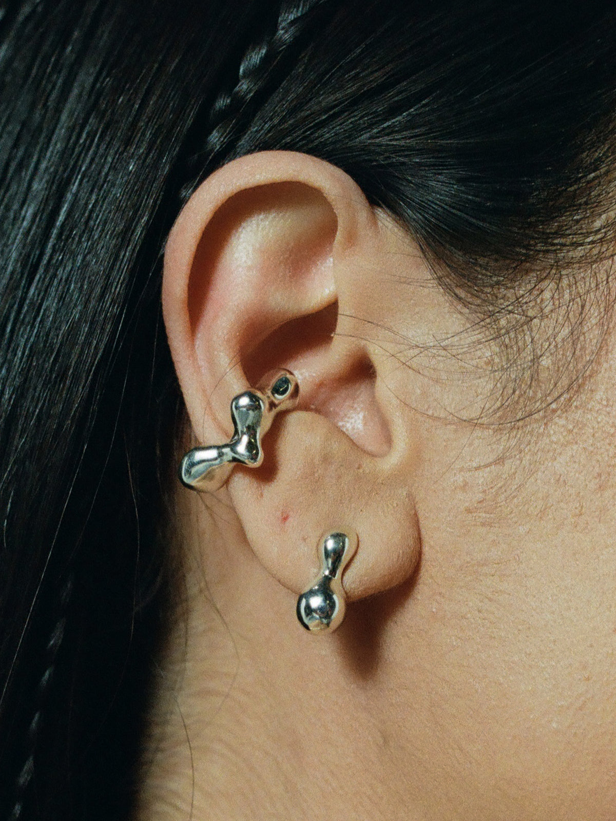 Close up of FARIS CHAMELLE Stud in Sterling Silver shown on model. Styled with SEEP Ear Cuff in Sterling Silver.