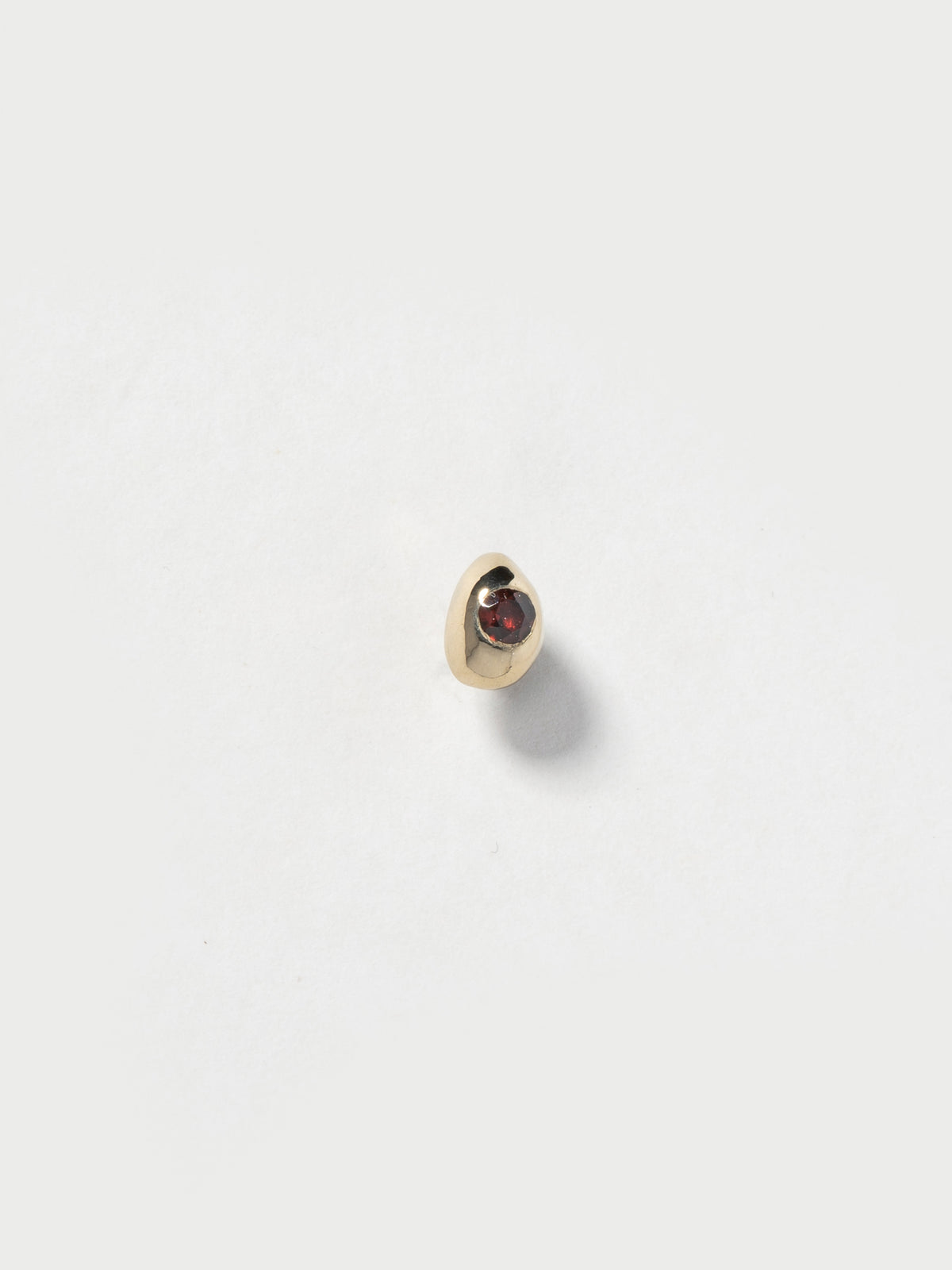 Product image of FARIS EGG GEM Stud with garnet (front view)
