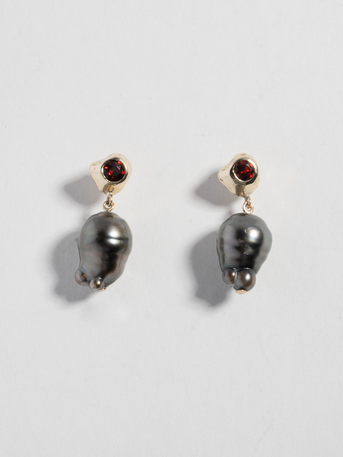 Product image of FARIS KIRA PERLA Earrings in 14k gold with garnet and black Tahitian pearls (positioned side by side, front view)