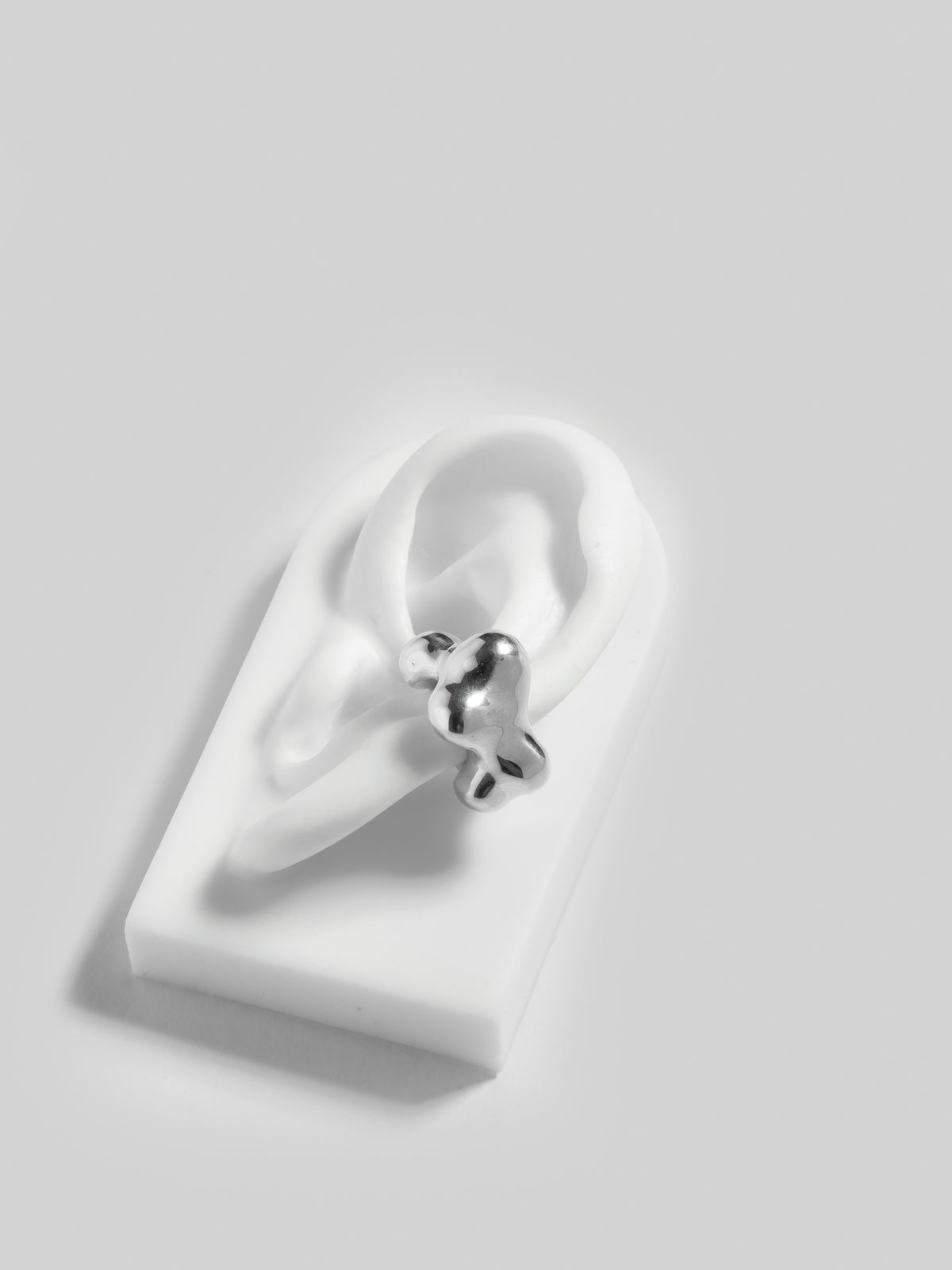 FARIS KUMO Ear Cuff in sterling silver shown on silicone ear display