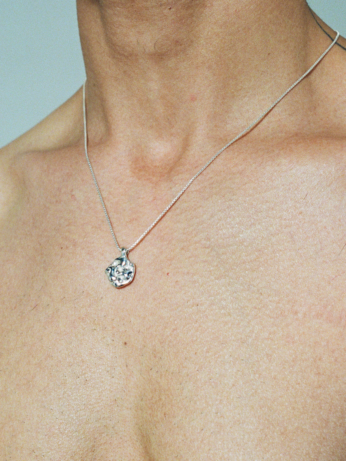 LAVA DIME Pendant in sterling silver on model