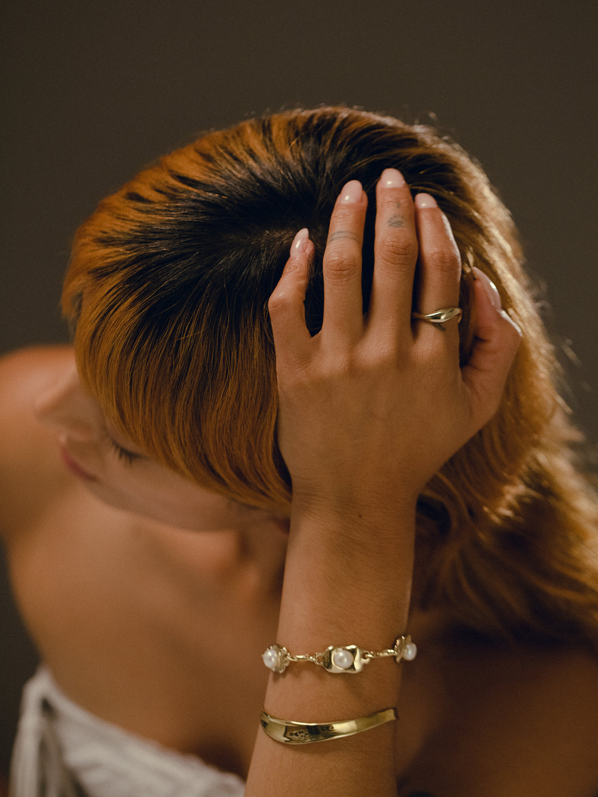 RIVER ring, OSTRA bracelet, and RIVER cuff in gold plated bronze on model