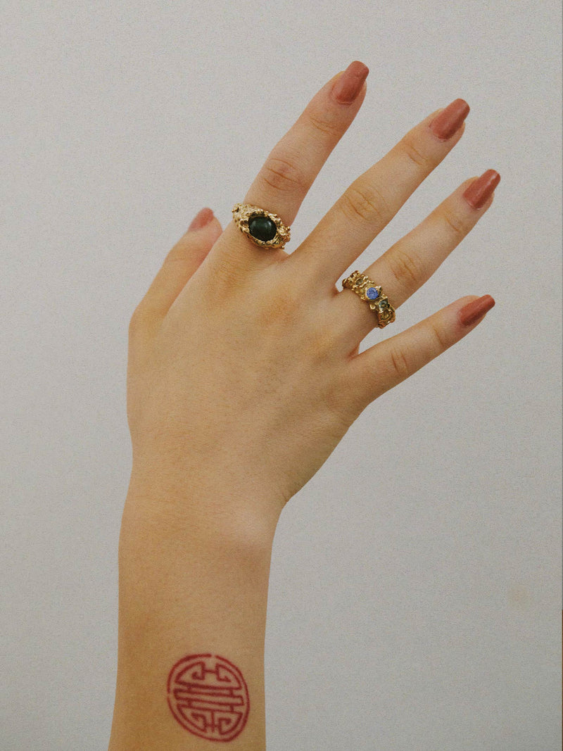 FARIS ROCA GEM Band in gold-plated bronze with lab-create blue and green sapphire worn on model. Styled with ROCA EYE Ring in gold-plated bronze with jade