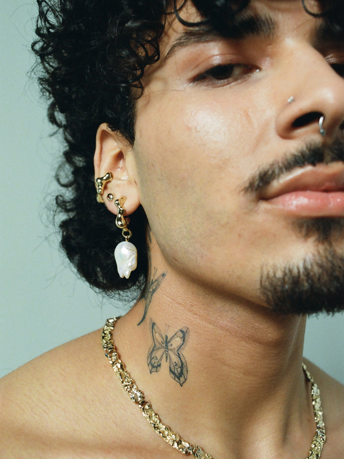 FARIS SEEP BAROQUE Drop Earrings in 14k Gold Plate shown on male model, styled with EGG GEM Stud in 14k Gold/Garnet, SEEP Ear Cuff in 14k Gold Plate, and BRUTO Collar in 14k Gold Plate