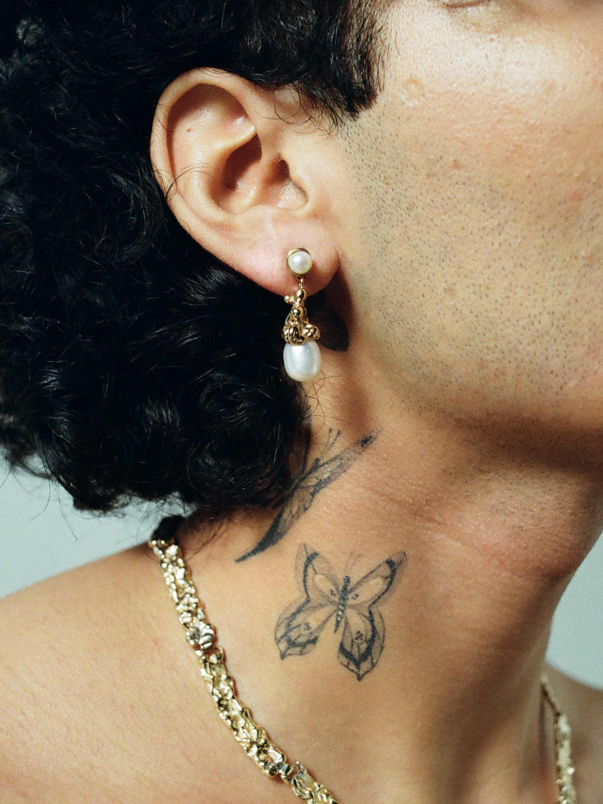 FARIS SOPHIA Drop Earrings in 14k Gold Plate shown on male model, styled with BRUTO Collar in 14k Gold Plate