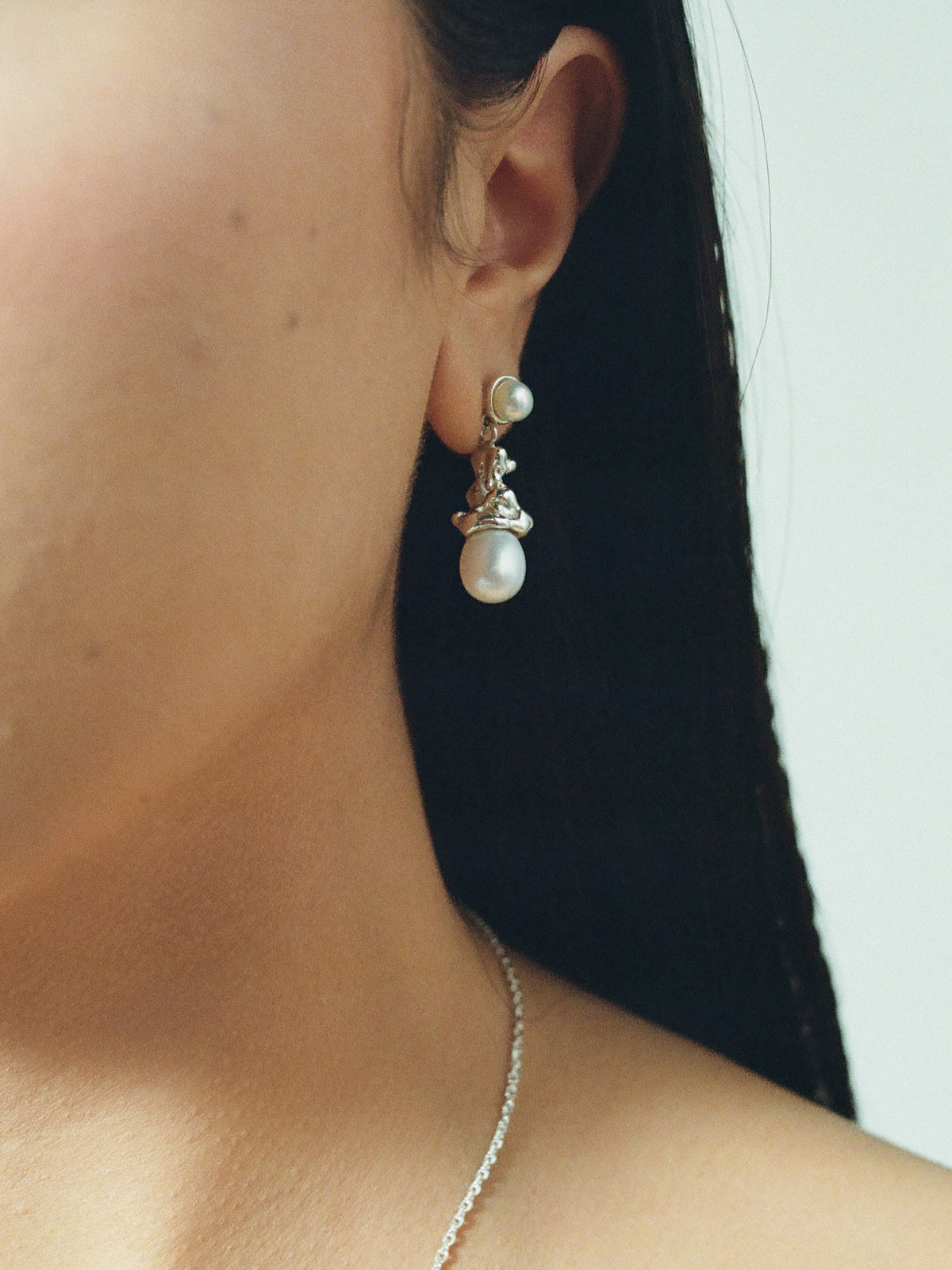 Close up image of FARIS SOPHIA Drops in sterling silver, shown on models left ear