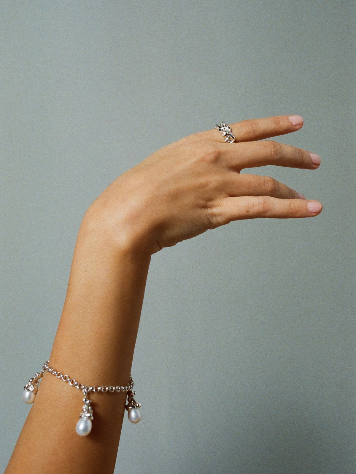 FARIS SOPHIA Charm Bracelet in sterling silver, shown on model. Styled with LAVA Band 10mm in sterling silver