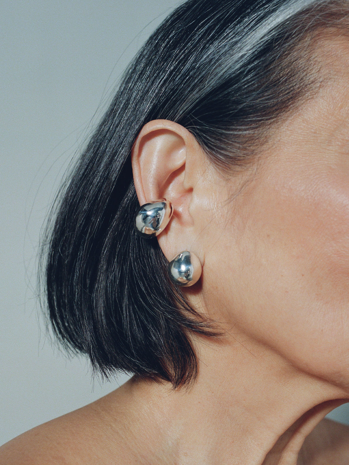 Close up image of FARIS SUMO Stud in sterling silver, shown on model. Styled with BOTERO Ear Cuff in sterling silver
