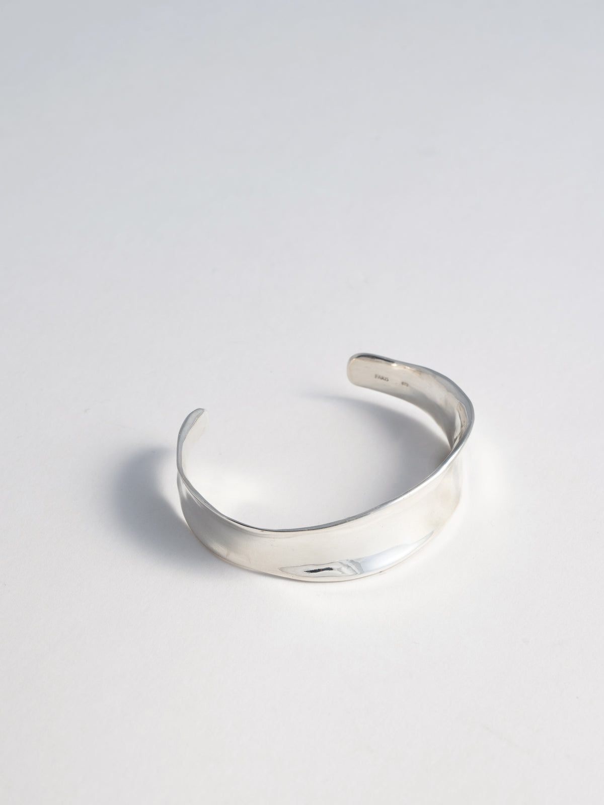 Product image of FARIS VERSUS Cuff in sterling silver, slightly turned to the side to show form