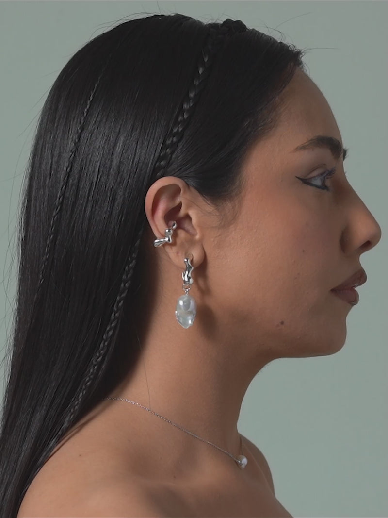 Short clip of FARIS SEEP Ear Cuff in sterling silver shown on model. Styled with SEEP BAROQUE Drops in sterling silver and KESHI Necklace in sterling silver