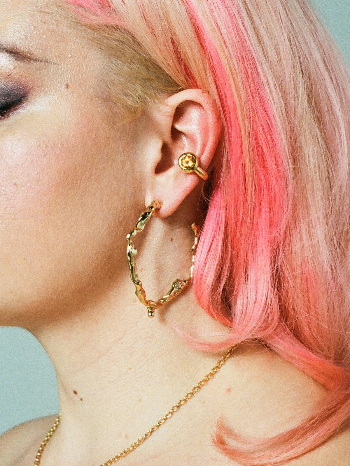 Model wearing FARIS OH Ear Cuff in gold-plated bronze with citrine, styled with DRIP Hoops in gold-plated bronze.
