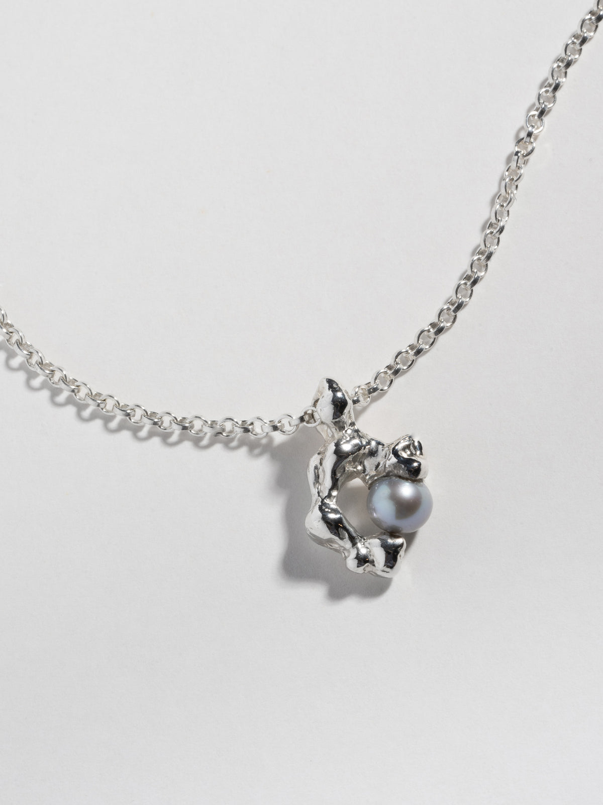 Close up of silver FELLINI Necklace pendant with grey freshwater pearl