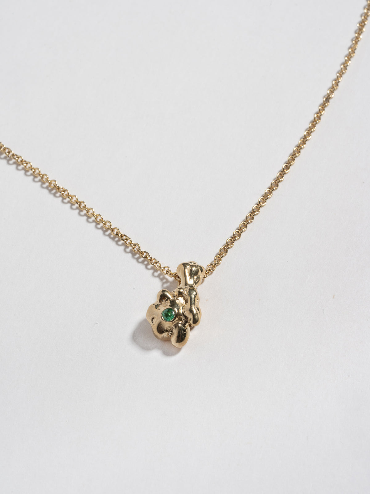 Close up image of 14k gold plated GOBBO Necklace pendant with emerald