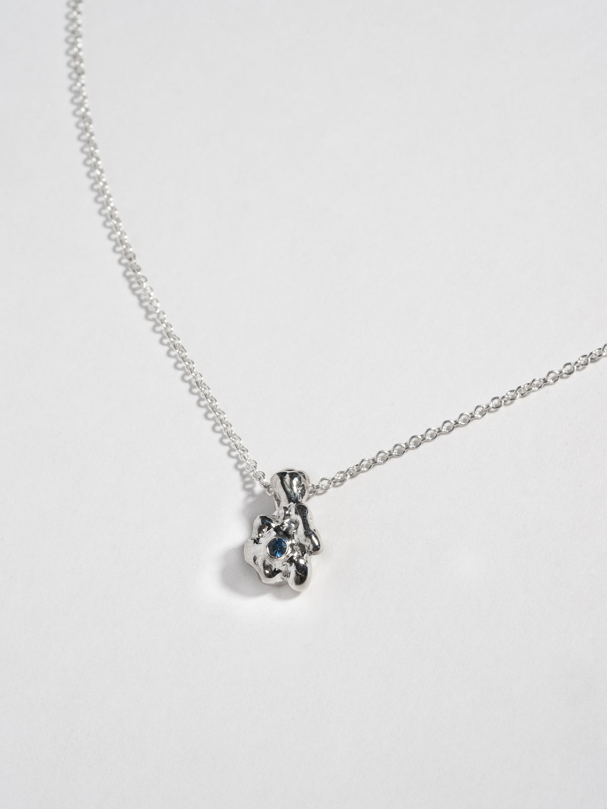 Close up of Sterling silver GOBBO Necklace pendant with blue sapphire