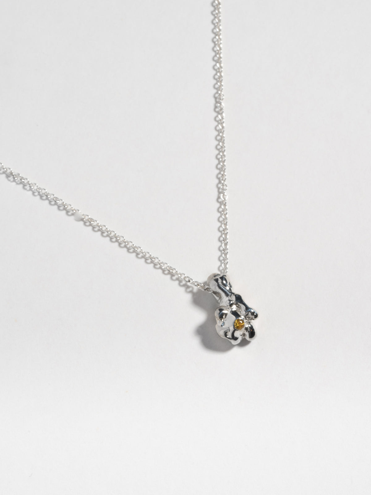 Close up image of Sterling silver GOBBO Necklace pendant with yellow sapphire