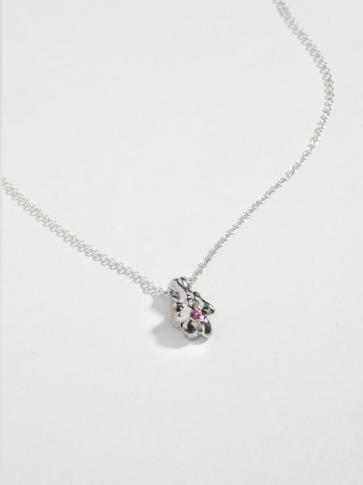 Close up image of Sterling silver GOBBO Necklace pendant with pink sapphire