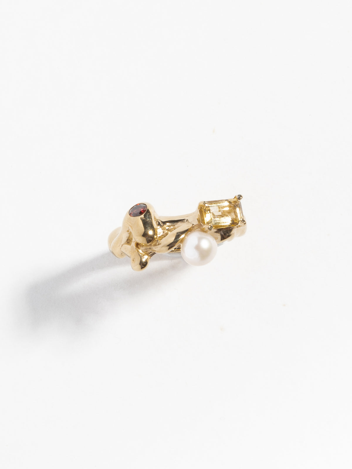 Product image of FARIS MENAGE Ring in gold-plated bronze with prong-set emerald-cut citrine, flush-set round, diamond-cut garnet, and a freshwater pearl. Front view.