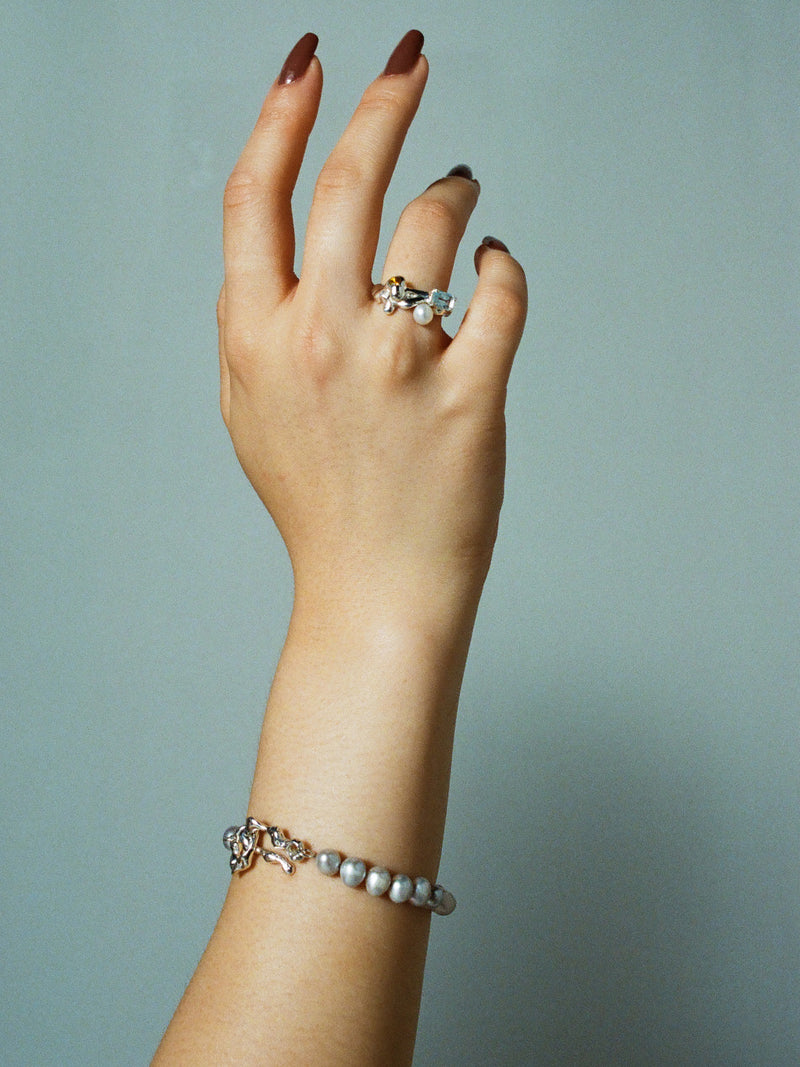 FARIS PATTA Bracelet in sterling silver with grey pearls shown on model, styled with MENAGE Ring in sterling silver with topaz and citrine
