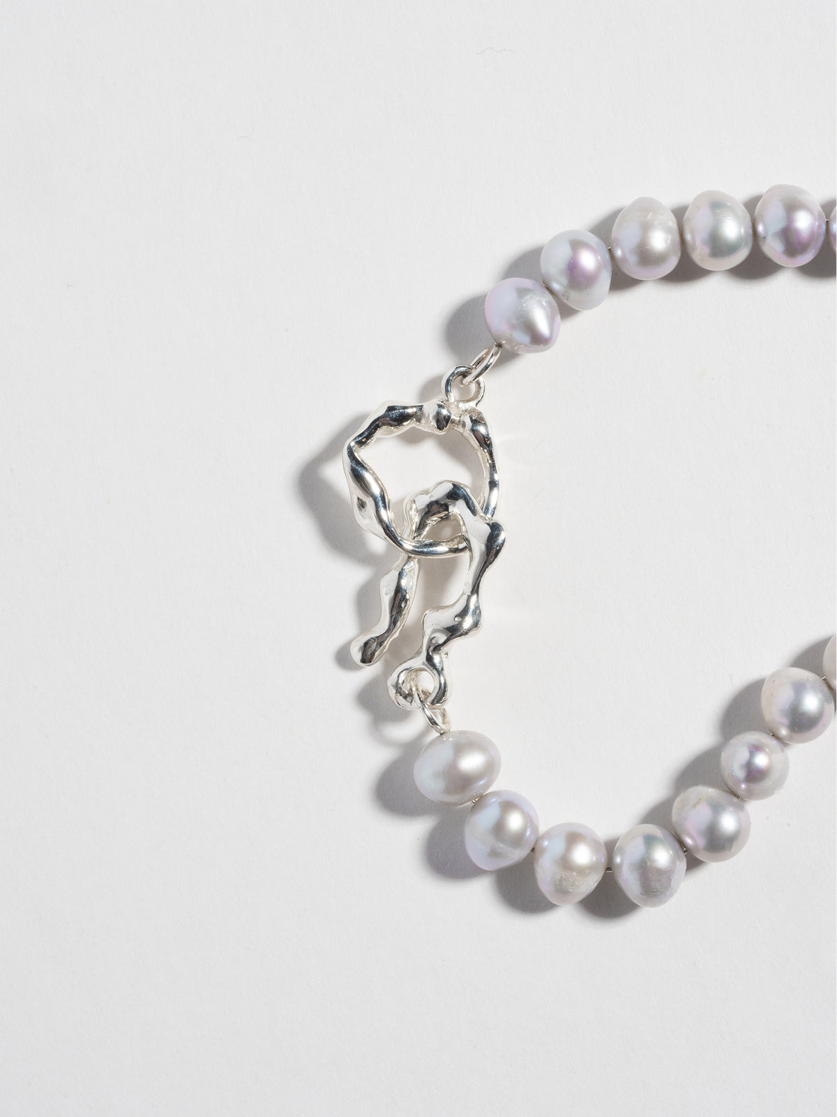 Close up image of hand-carved hook eye closure on FARIS PATTA Bracelet in sterling silver.