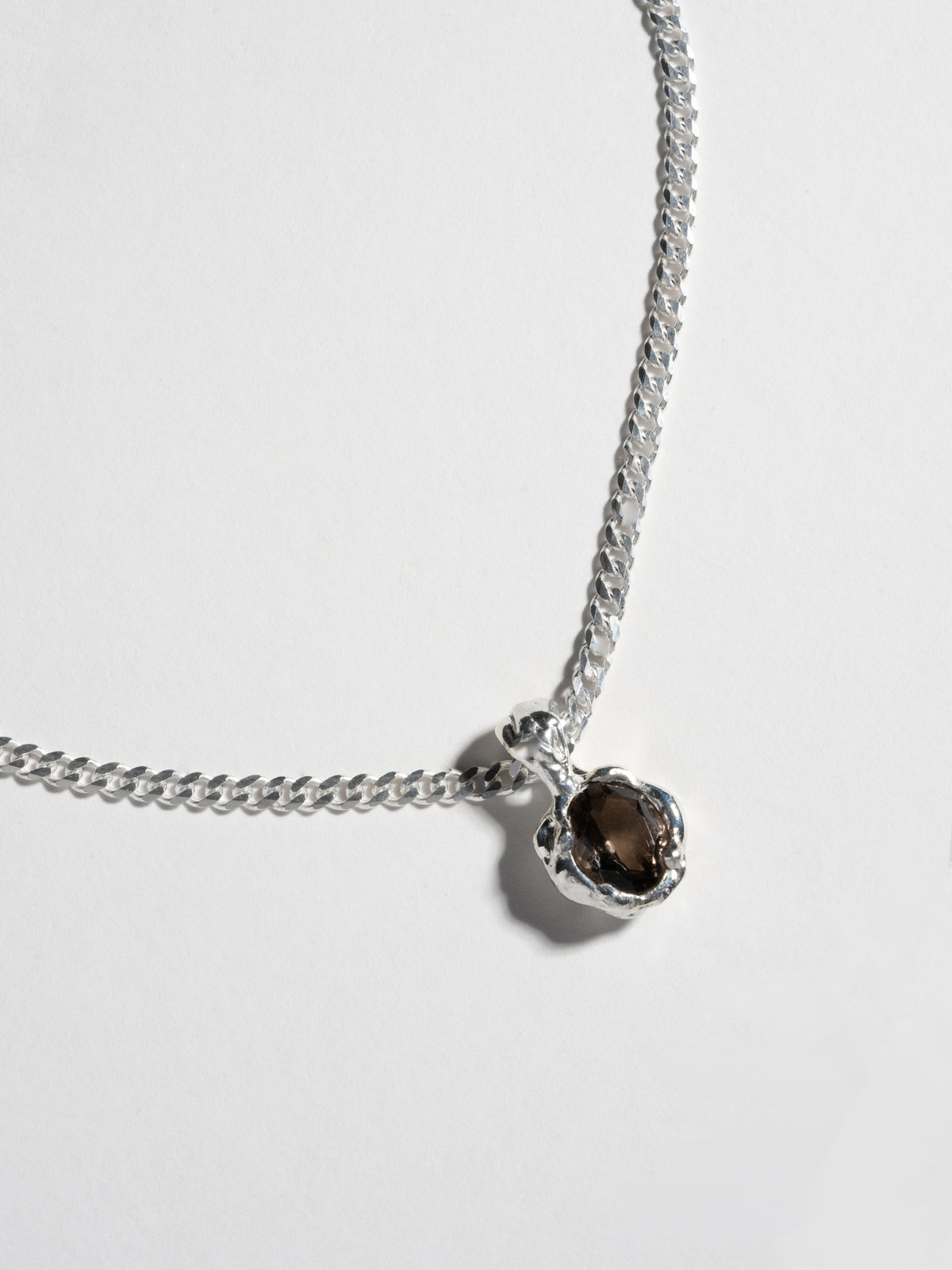 Close up of PRINCE Necklace pendant in sterling silver and smokey quartz