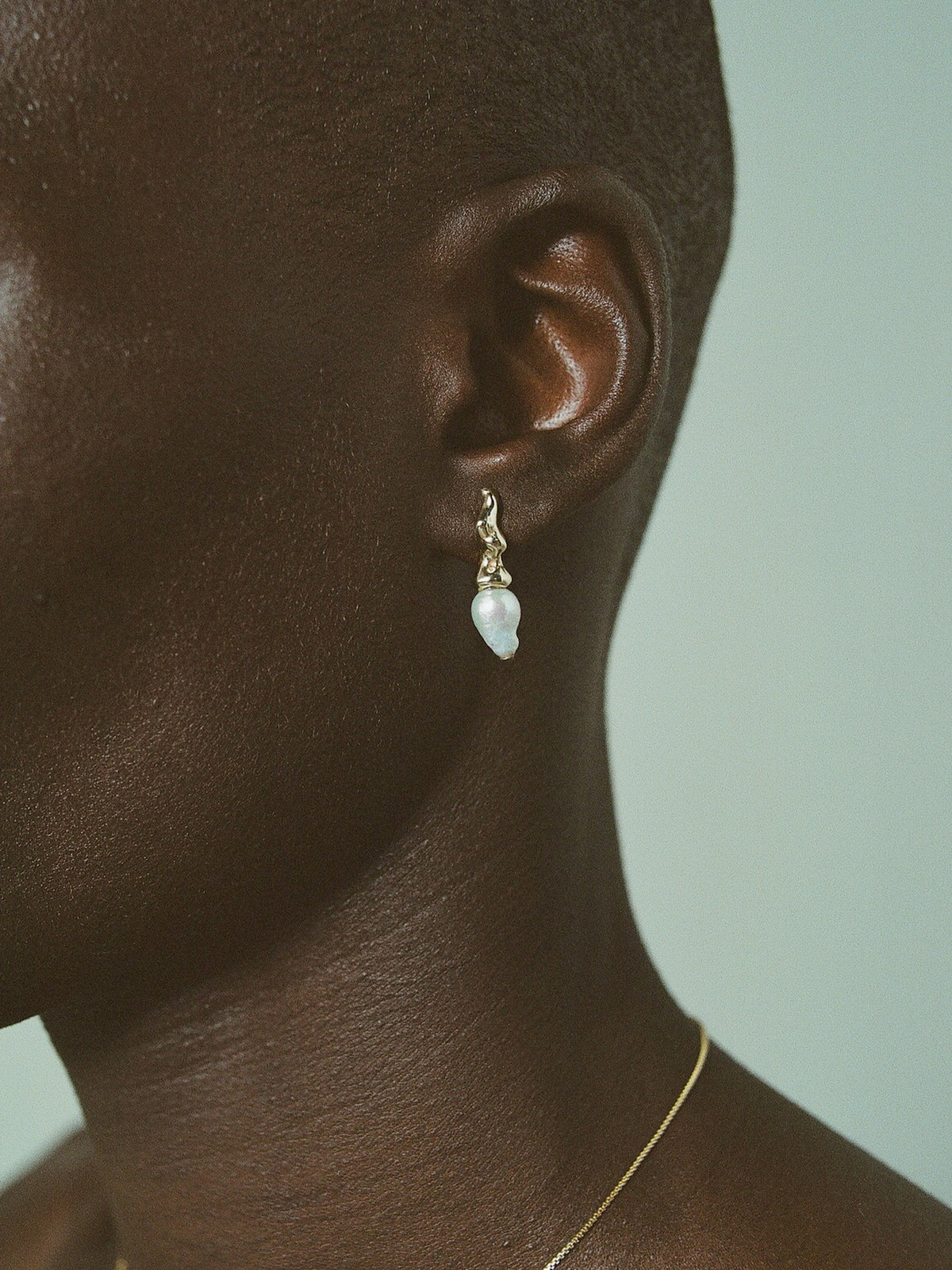 Close up image of FARIS SPRIG PERLA Earrings in 14k gold, shown on model