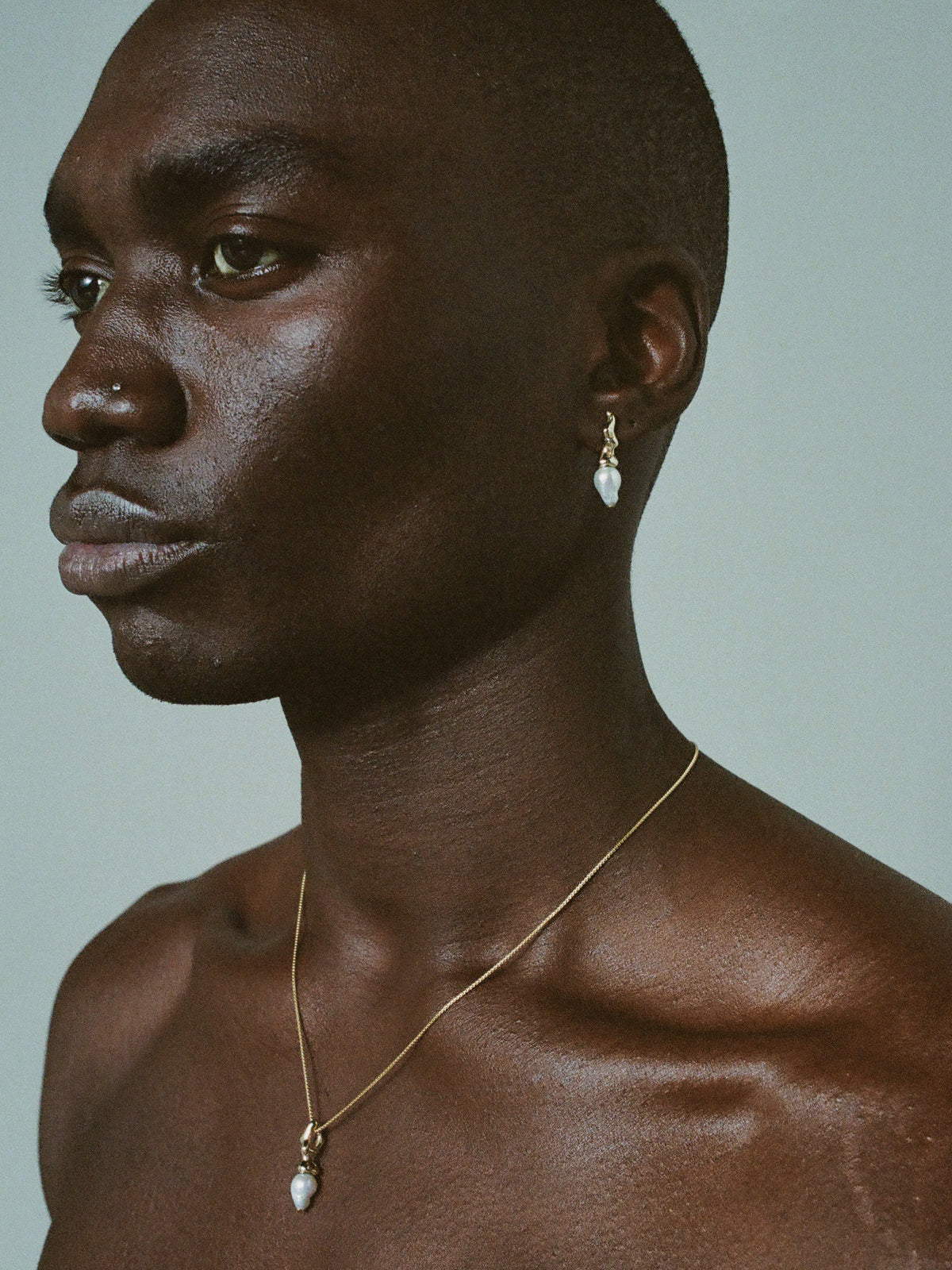 FARIS SPRIG PERLA Earrings in 14k gold shown on male model, styled with SPRIG Necklace in 14k gold-plated bronze.