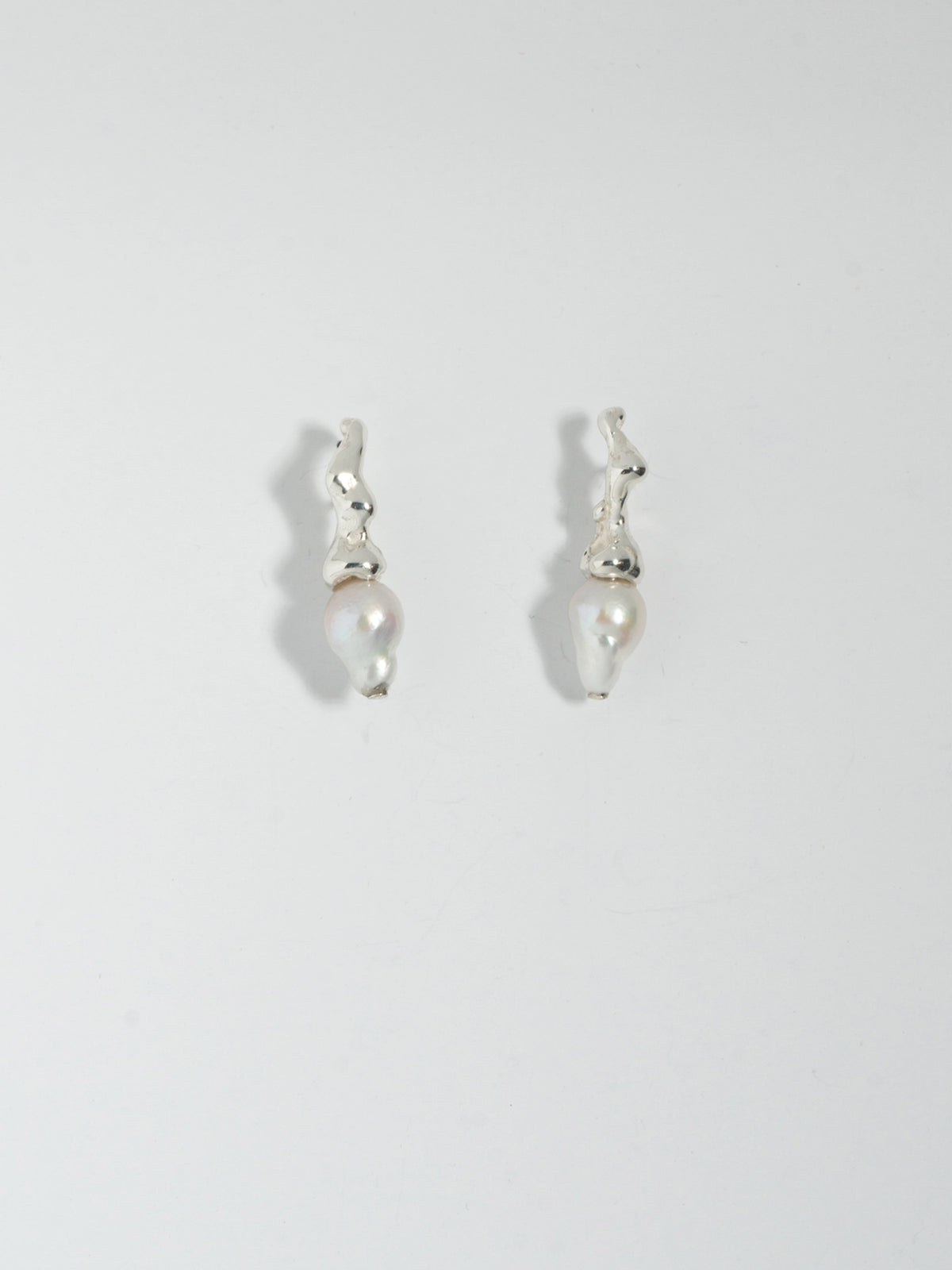 Product image of FARIS SPRIG PERLA Earrings in sterling silver. Laid side by side, front view